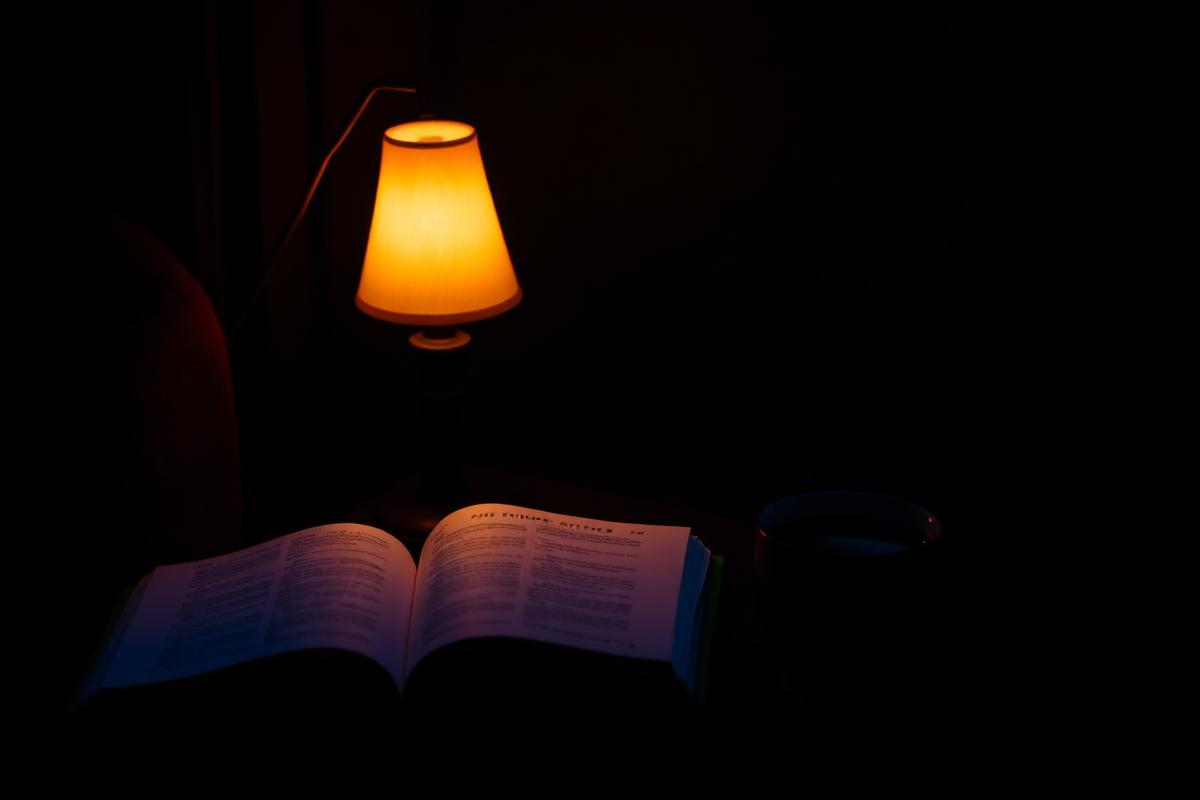Cosy bedroom lit by warm low light during wind-down